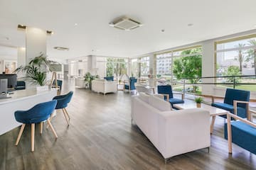 a room with white furniture and blue chairs