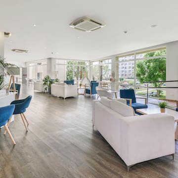 a room with white furniture and blue chairs