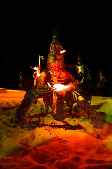 a man in garment with a fire in his hand