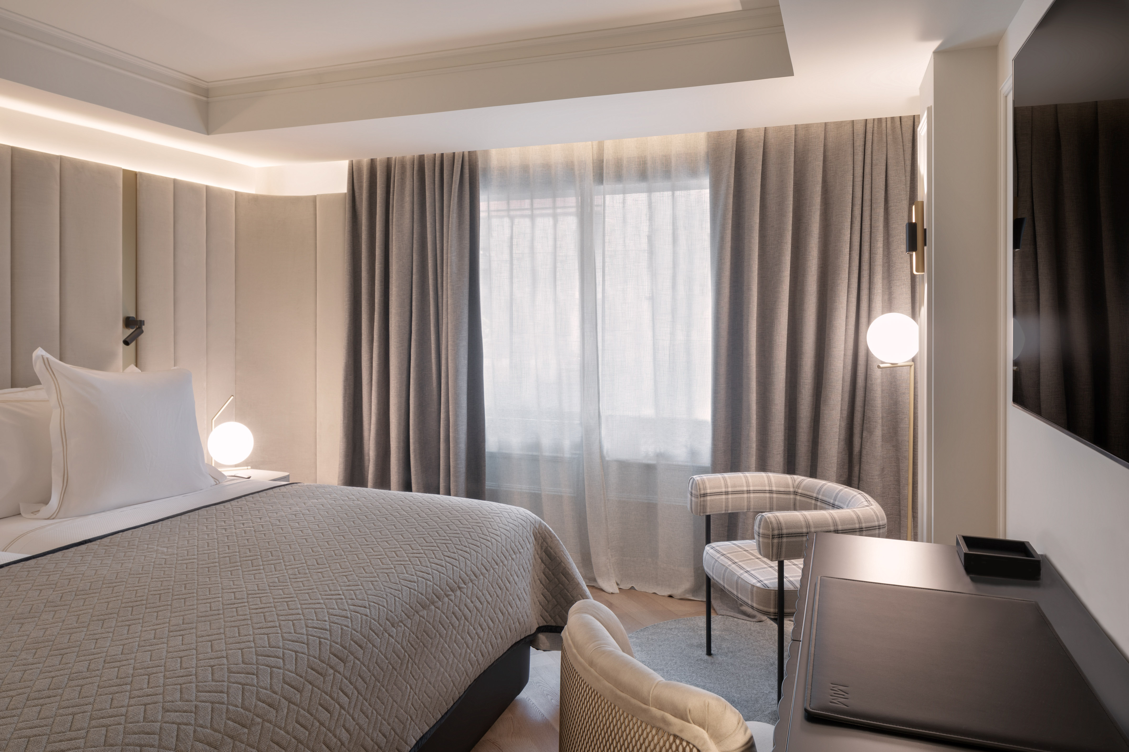 a bedroom with a bed and a chair