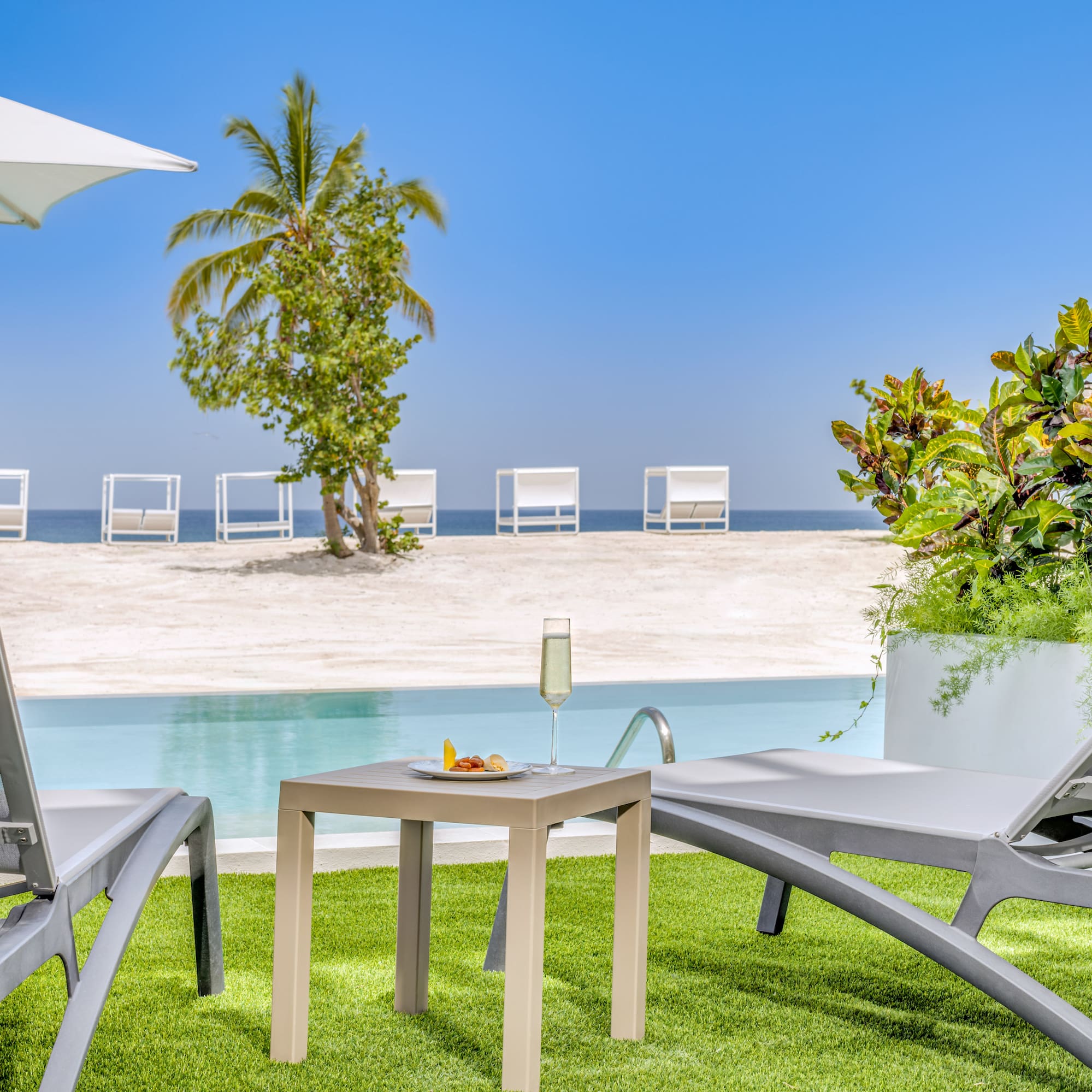a pool with a table and chairs