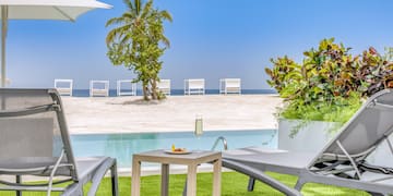 a pool with a table and chairs