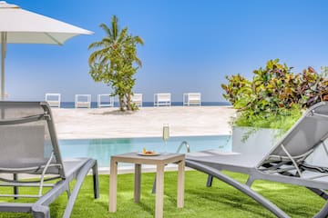 a pool with a table and chairs