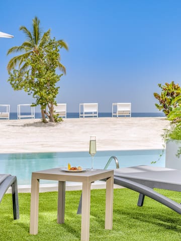 a pool with a table and chairs