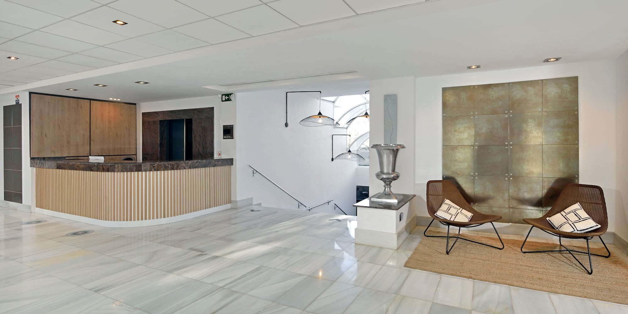 a lobby with a chair and a marble floor