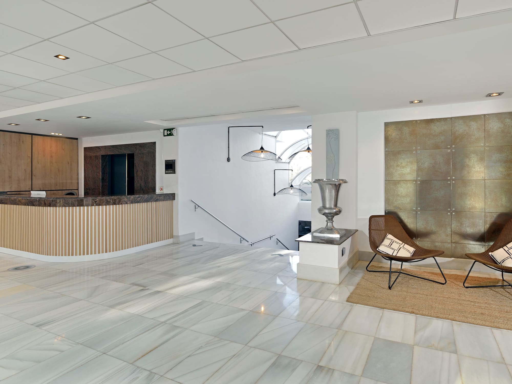 a lobby with a chair and a marble floor