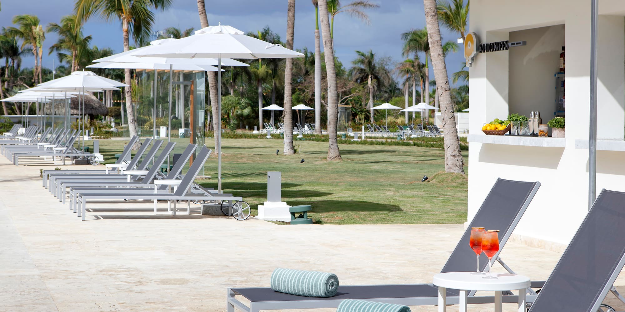 a lounge chairs and umbrellas outside of a building