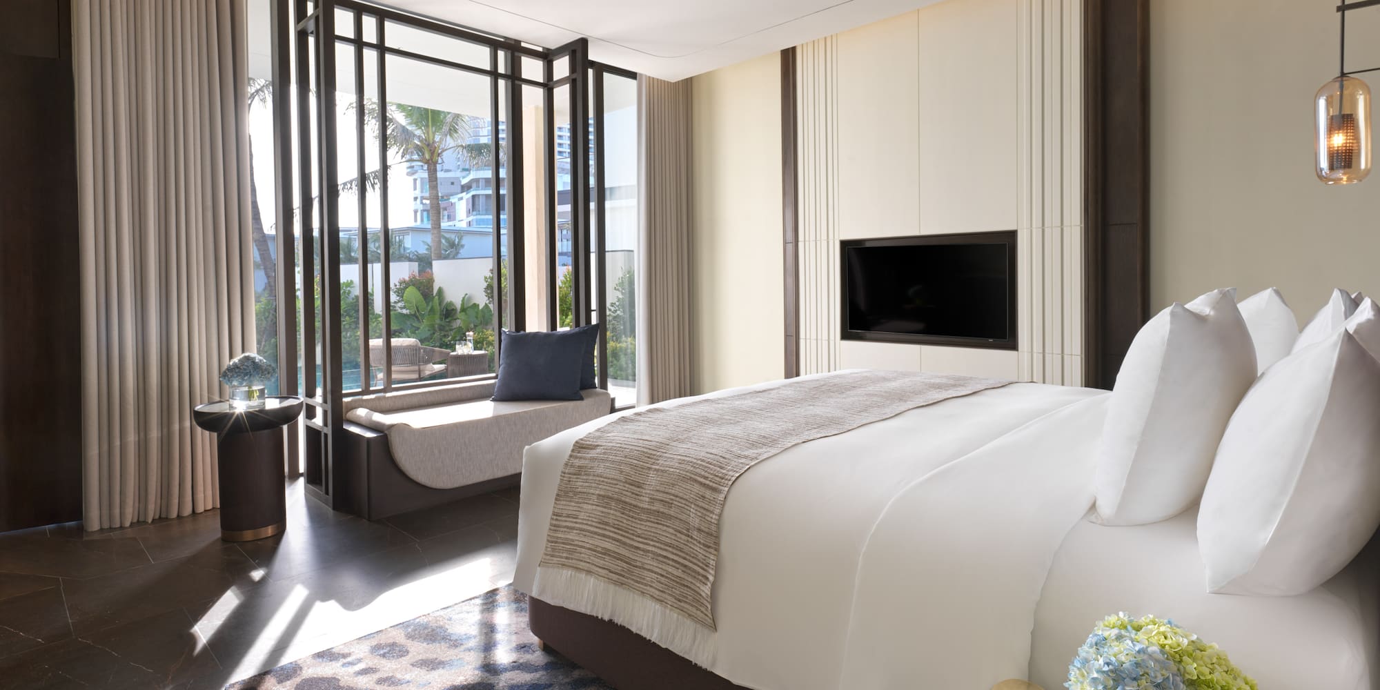 a bedroom with a television and a window