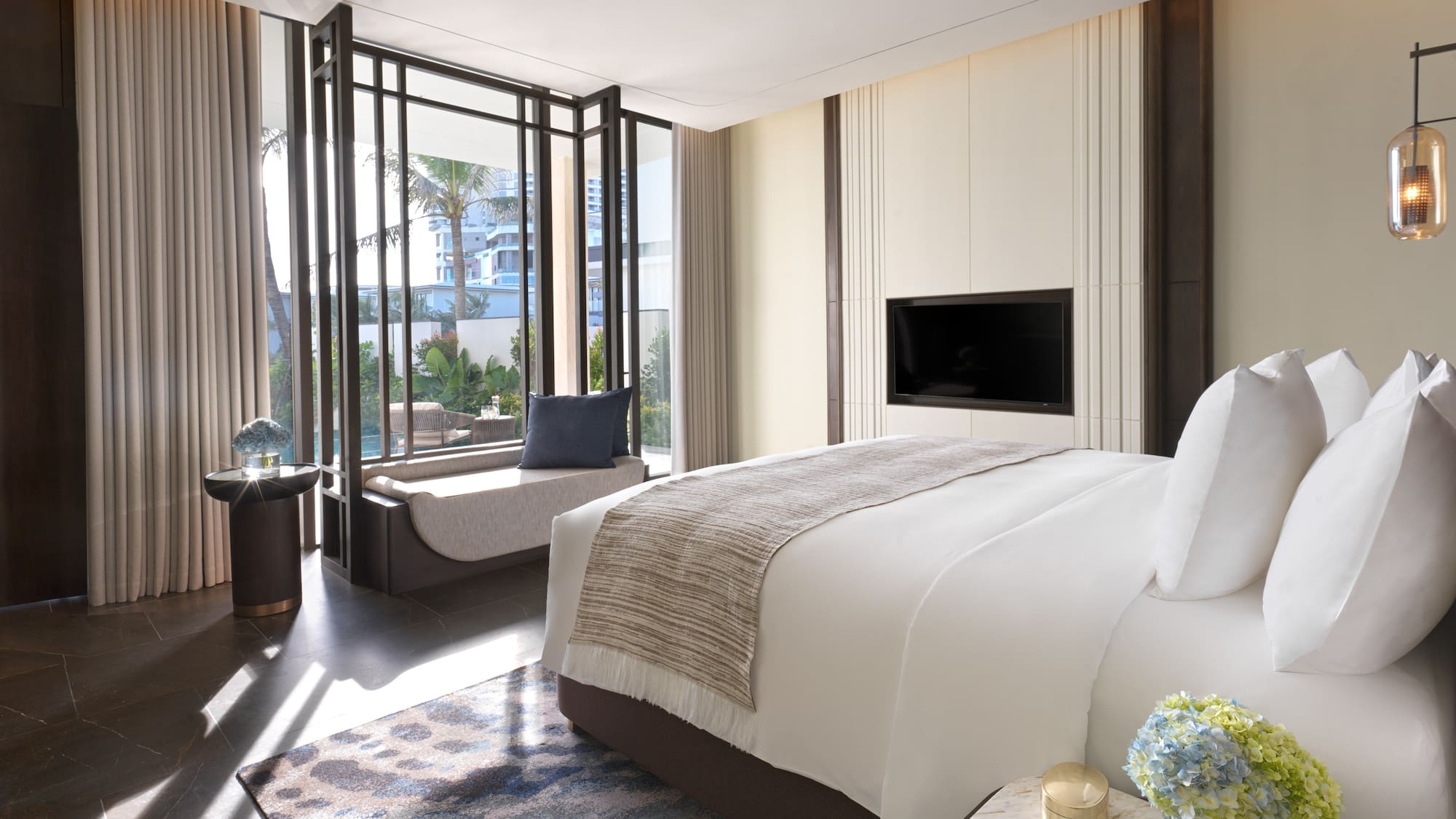 a bedroom with a television and a window