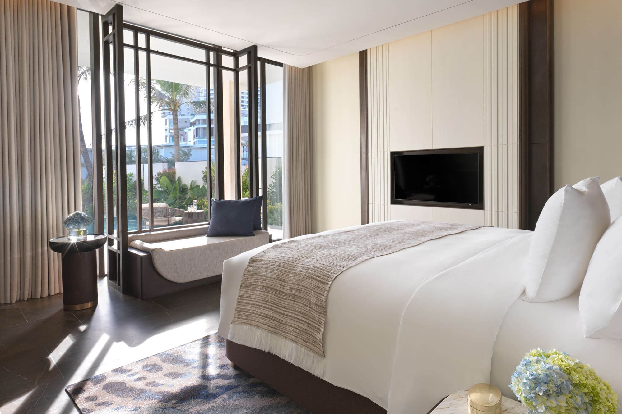 a bedroom with a television and a window