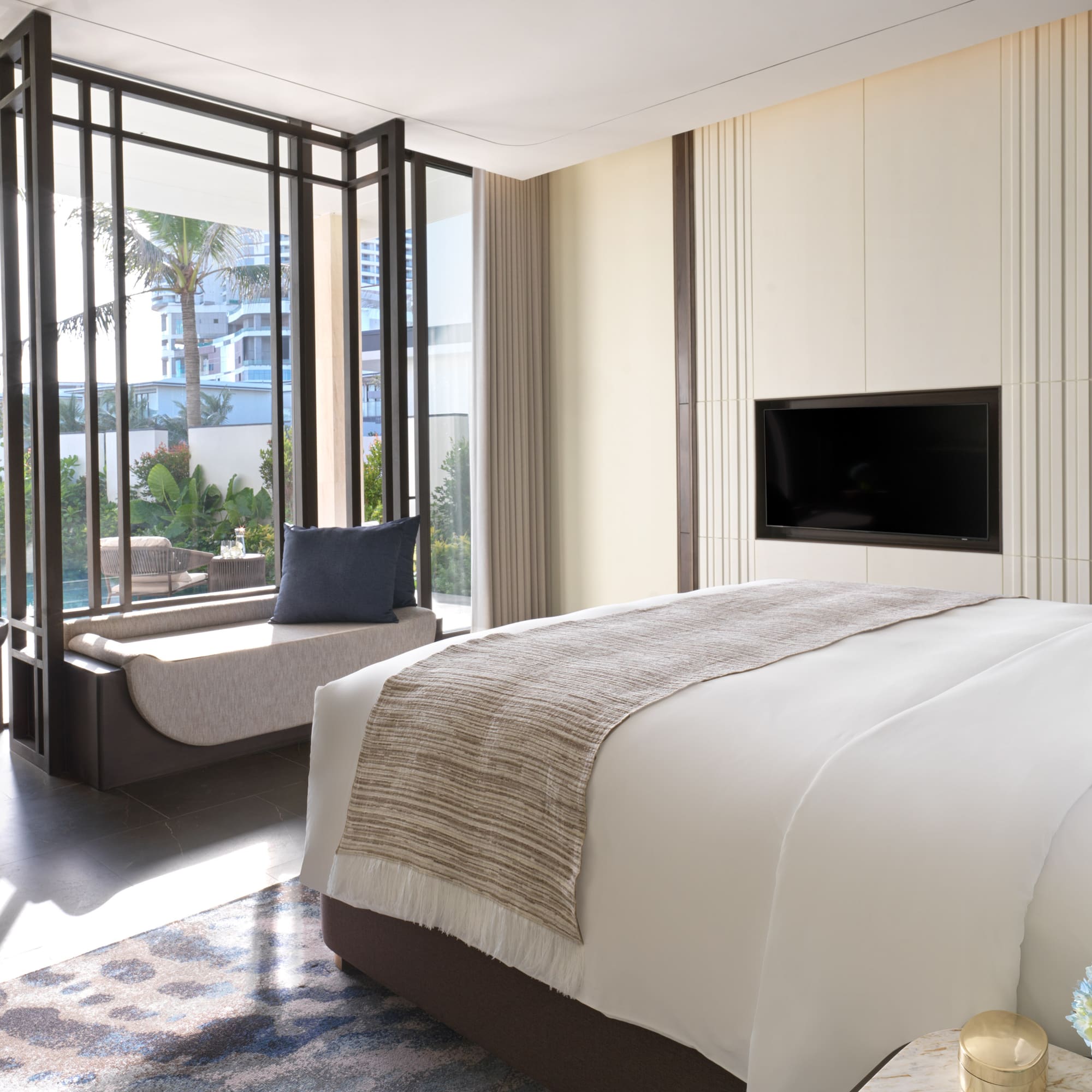 a bedroom with a television and a window