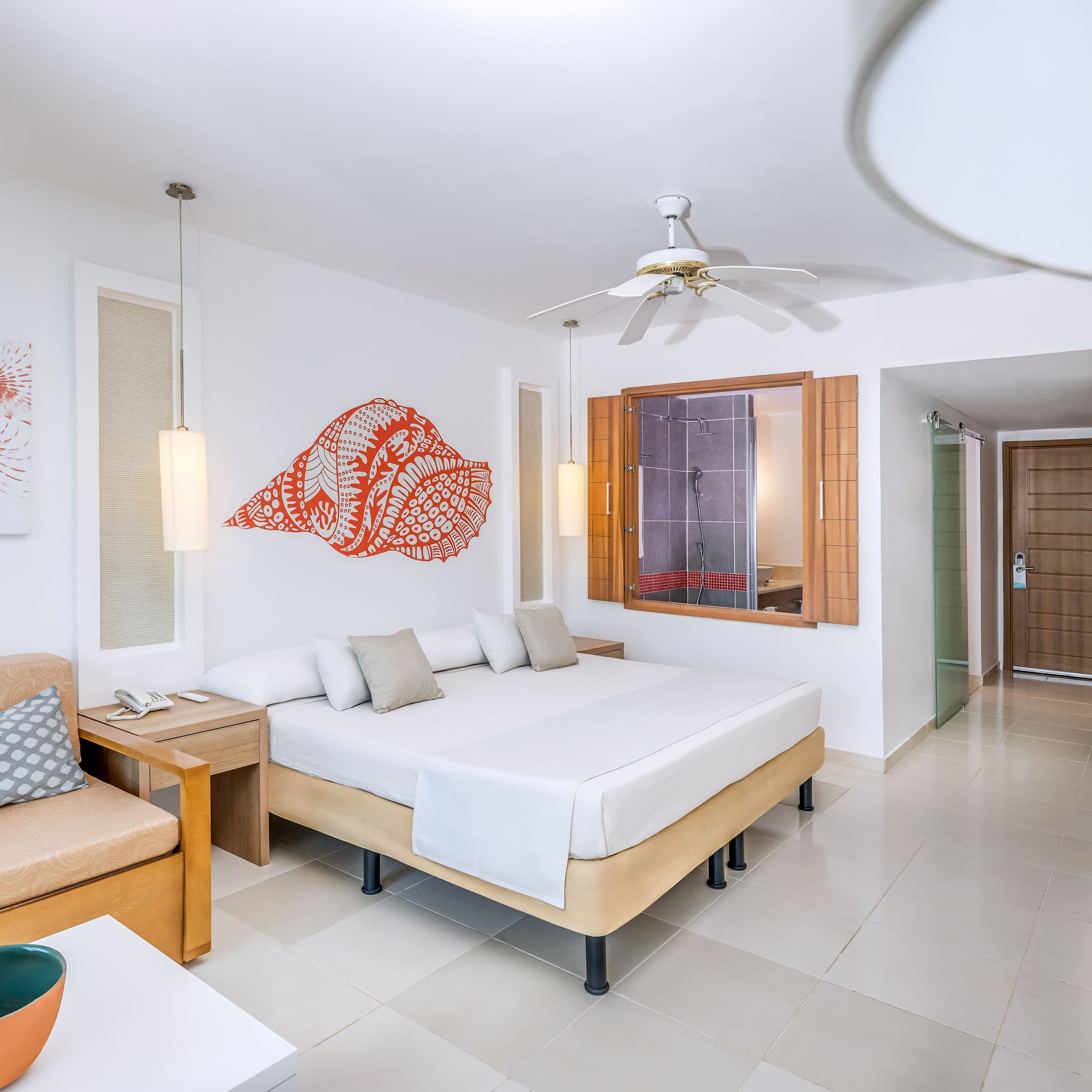 a room with a bed and a fan