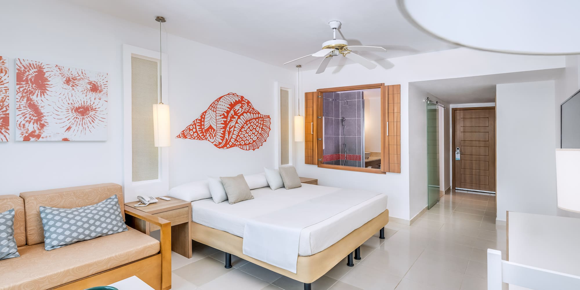 a room with a bed and a fan