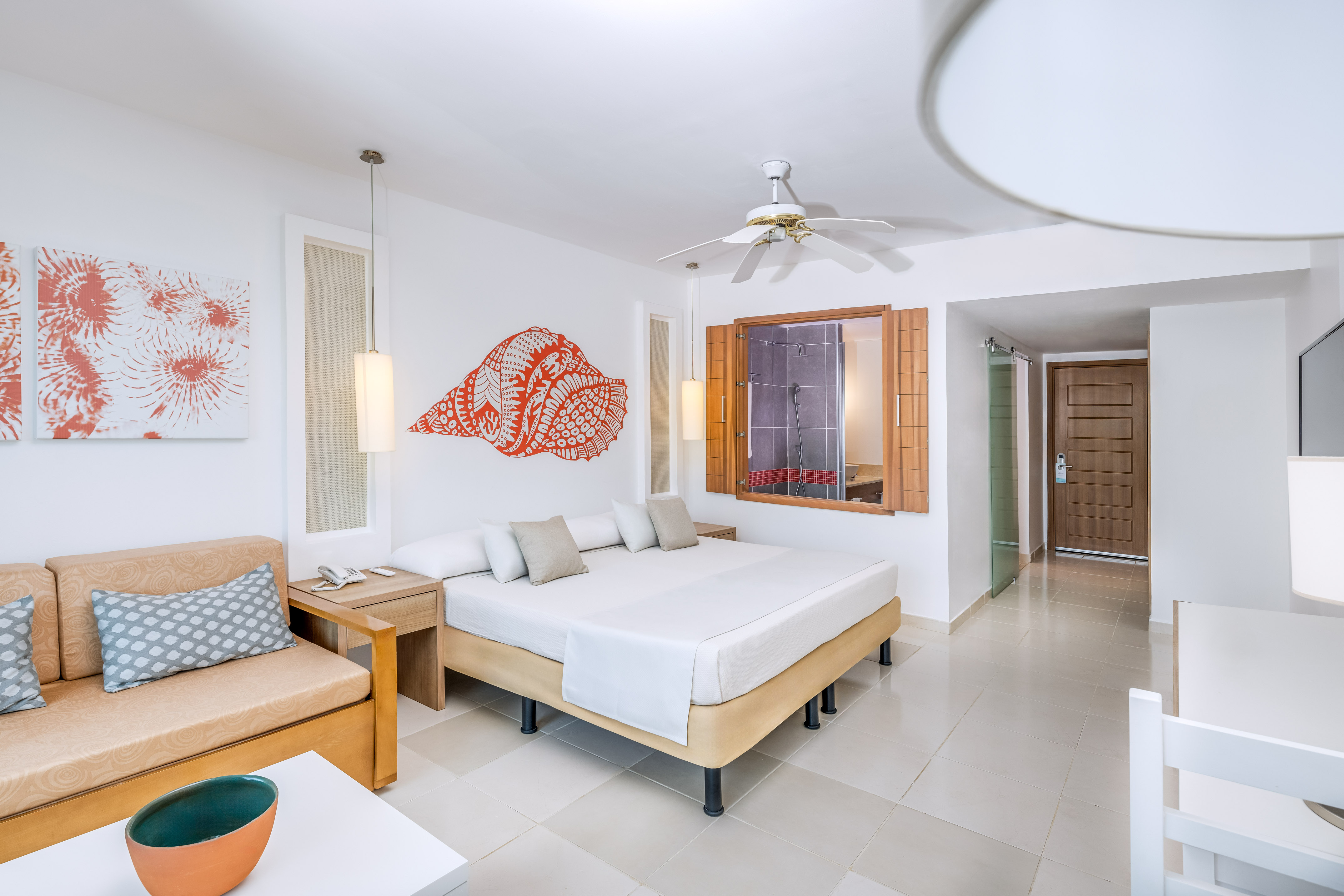 a room with a bed and a fan