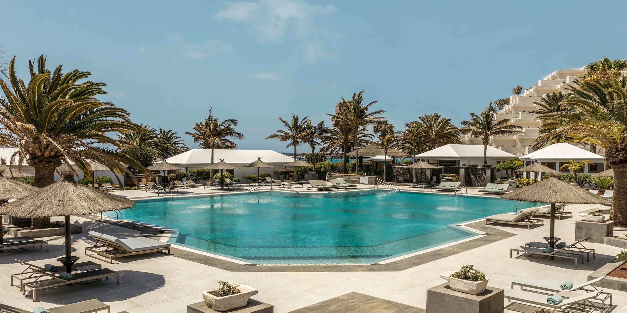 a pool with umbrellas and chairs