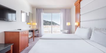 a room with two beds and a television