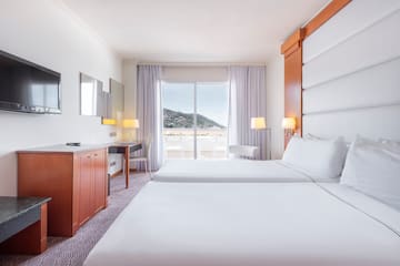 a room with two beds and a television