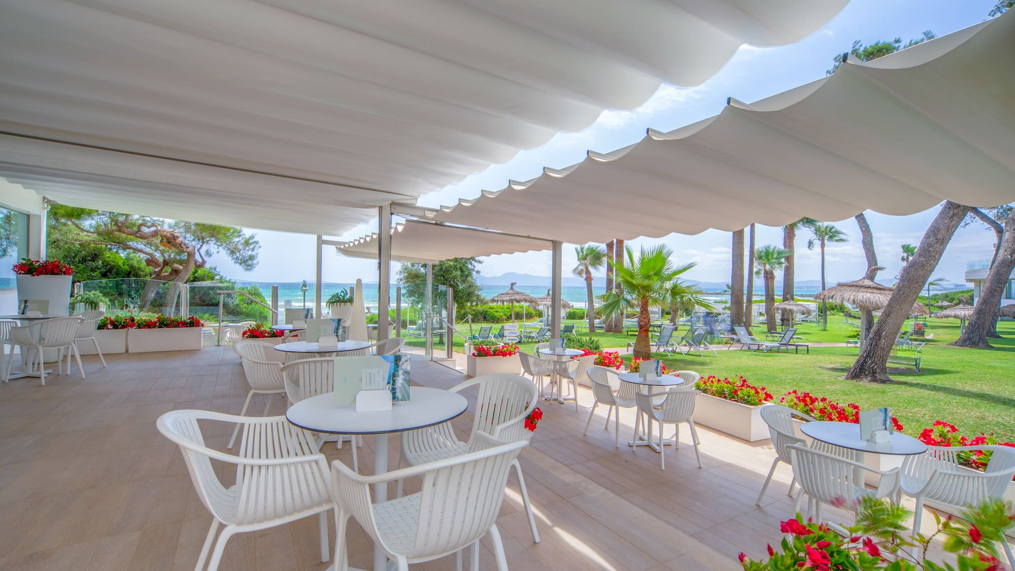 a white patio with tables and chairs