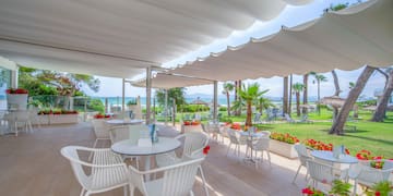 a white patio with tables and chairs