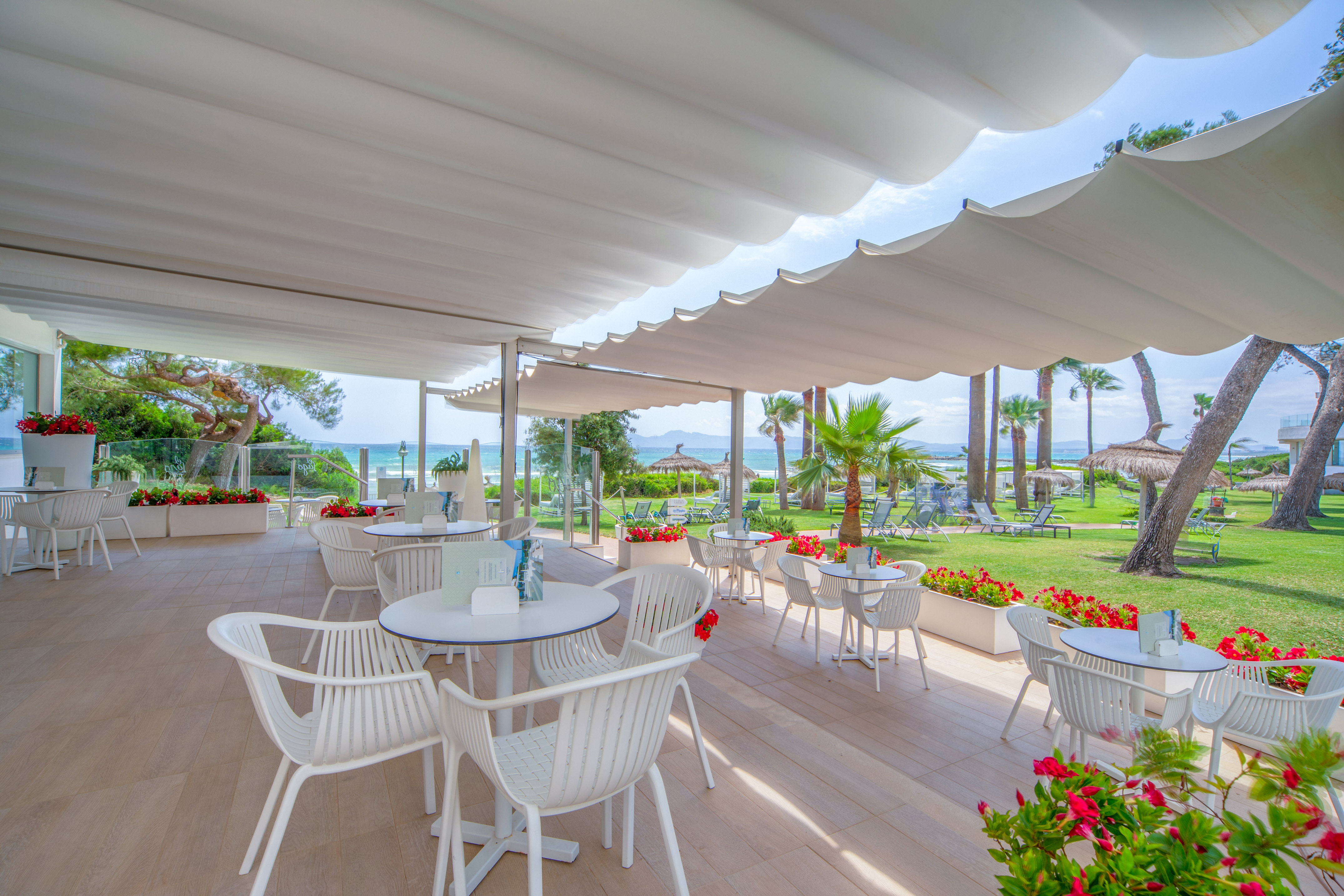 a white patio with tables and chairs