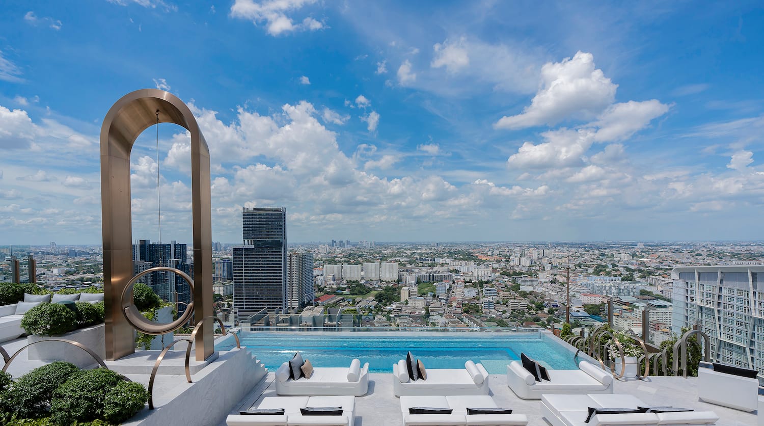 a pool with a view of a city and a blue sky