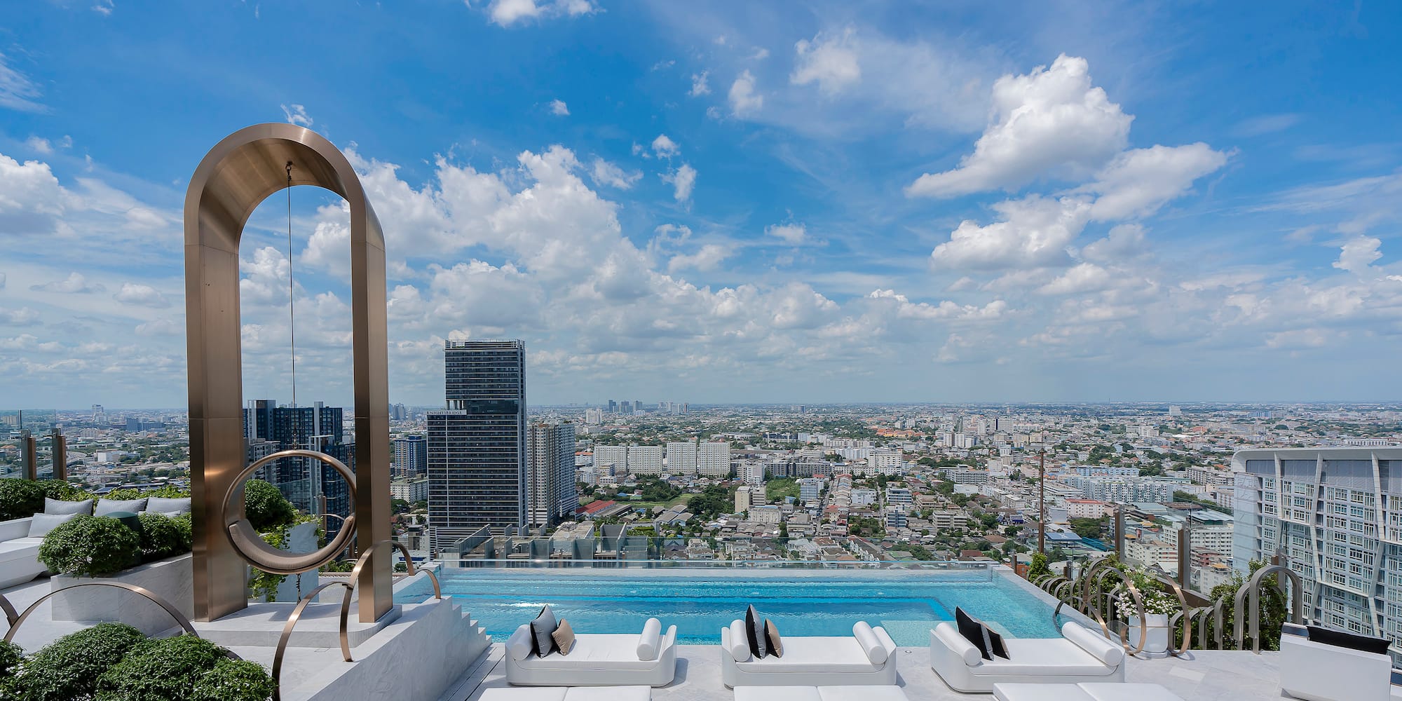 a pool with a view of a city and a blue sky