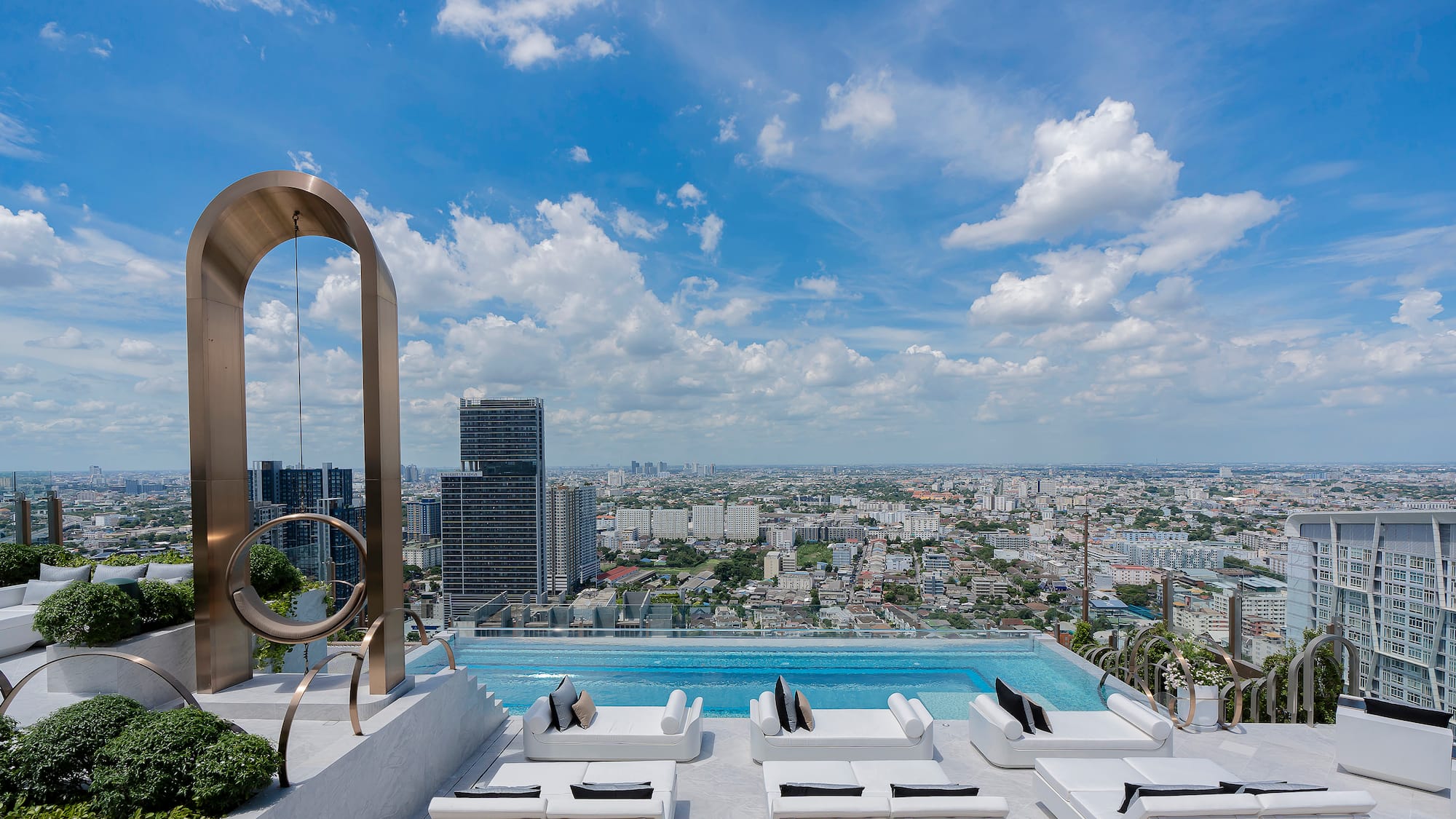 a pool with a view of a city and a blue sky