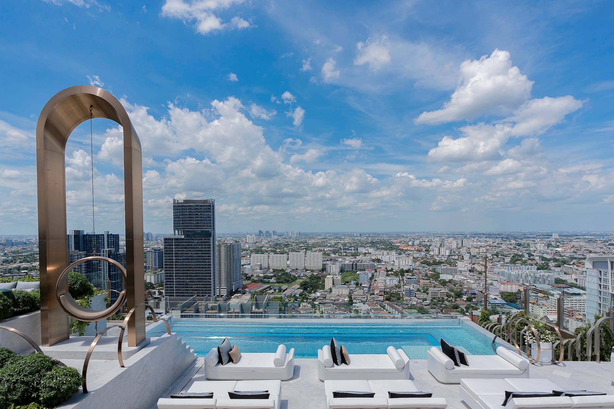 a pool with a view of a city and a blue sky