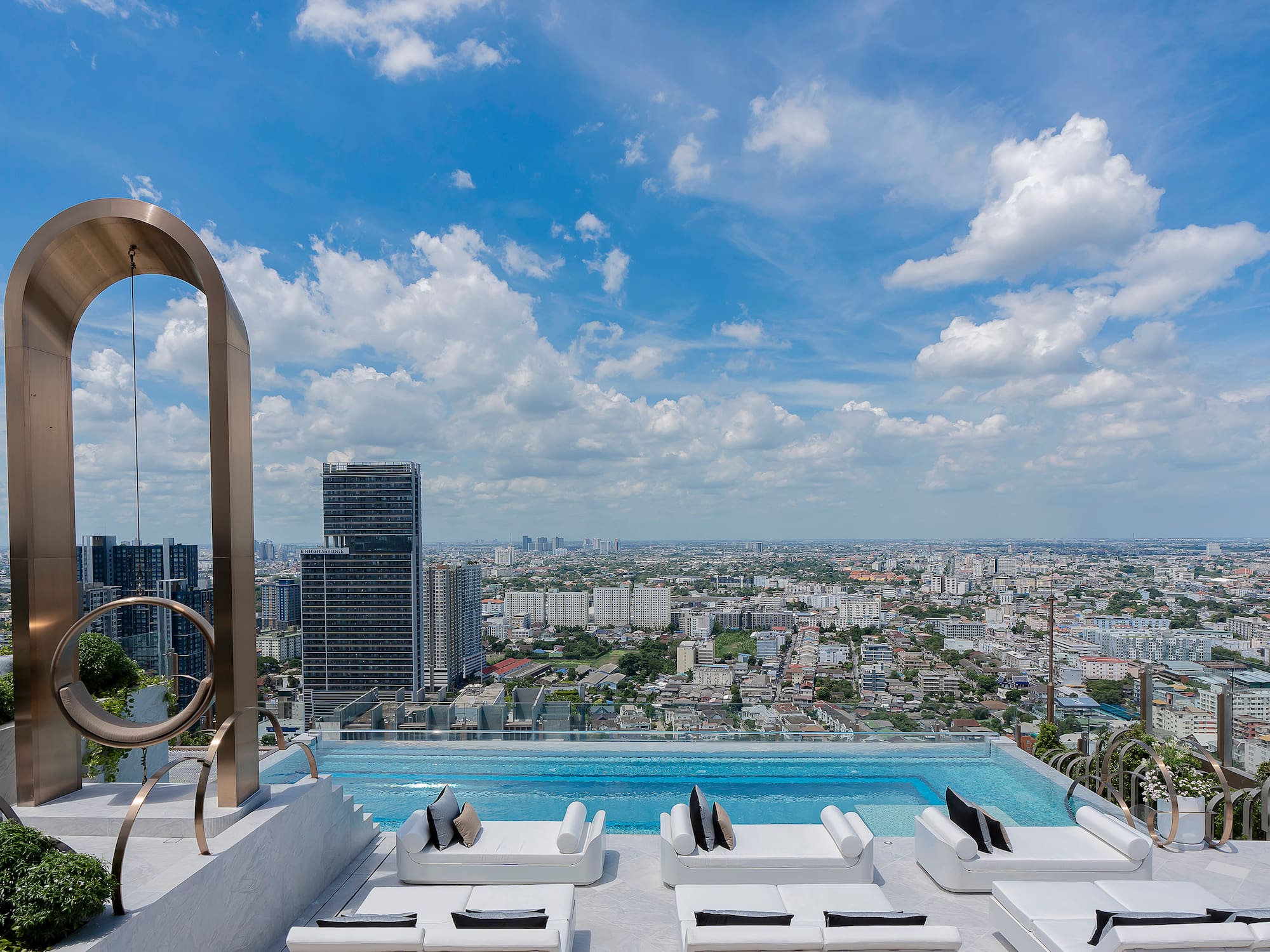 a pool with a view of a city and a blue sky