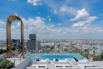 a pool with a view of a city and a blue sky
