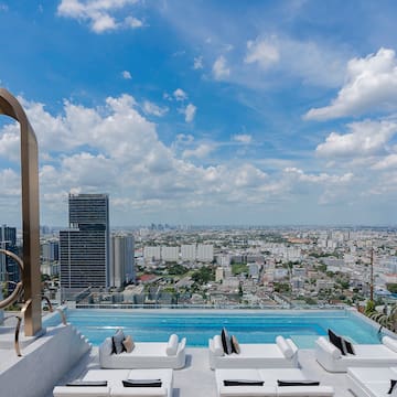 a pool with a view of a city and a blue sky