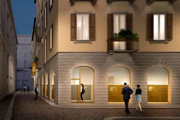 a group of people walking in front of a building