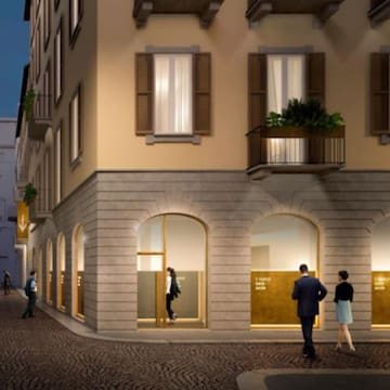 a group of people walking in front of a building