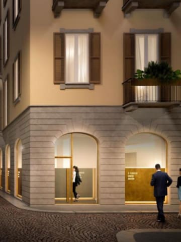 a group of people walking in front of a building