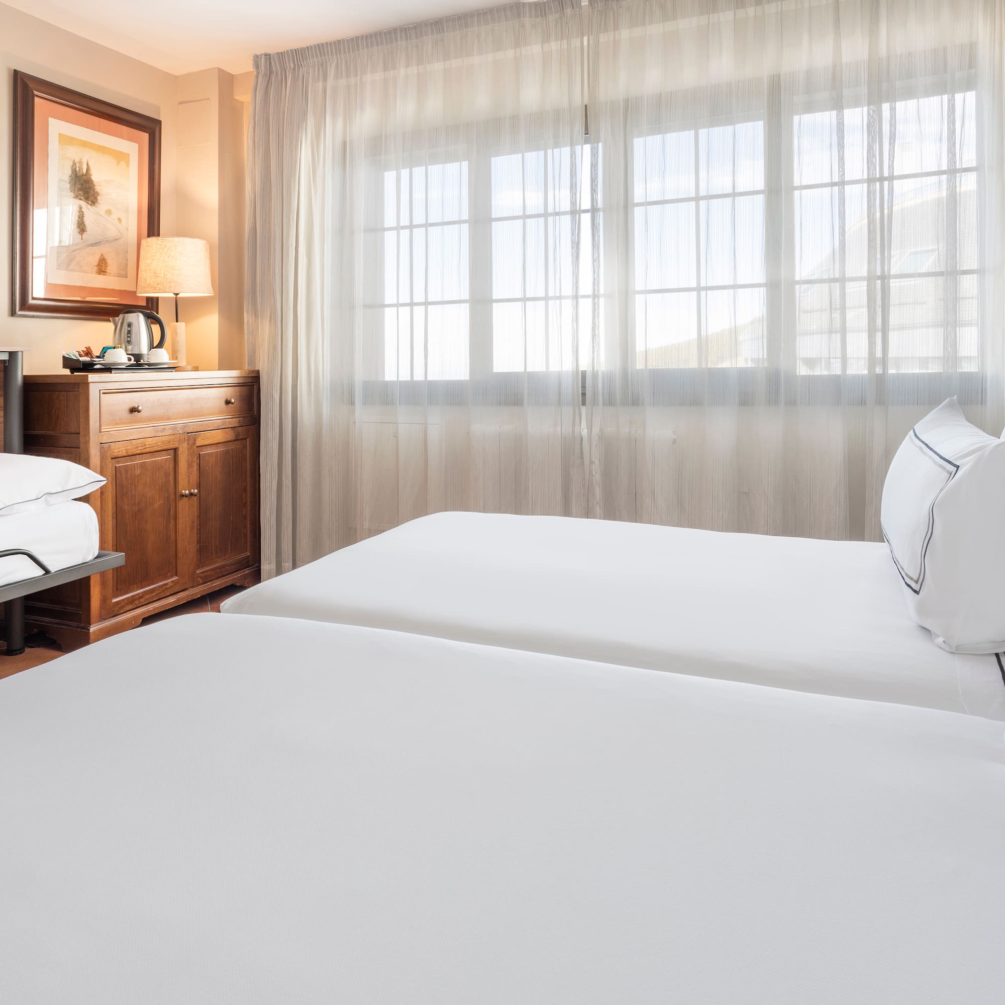 a room with two beds and a window