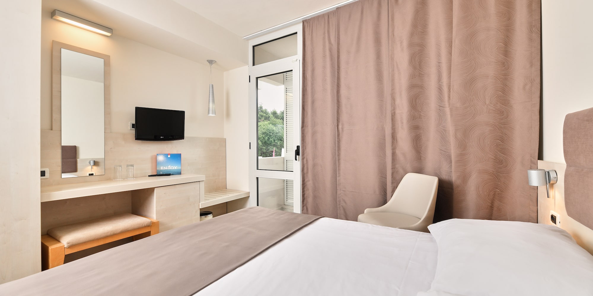 a room with a bed and a mirror