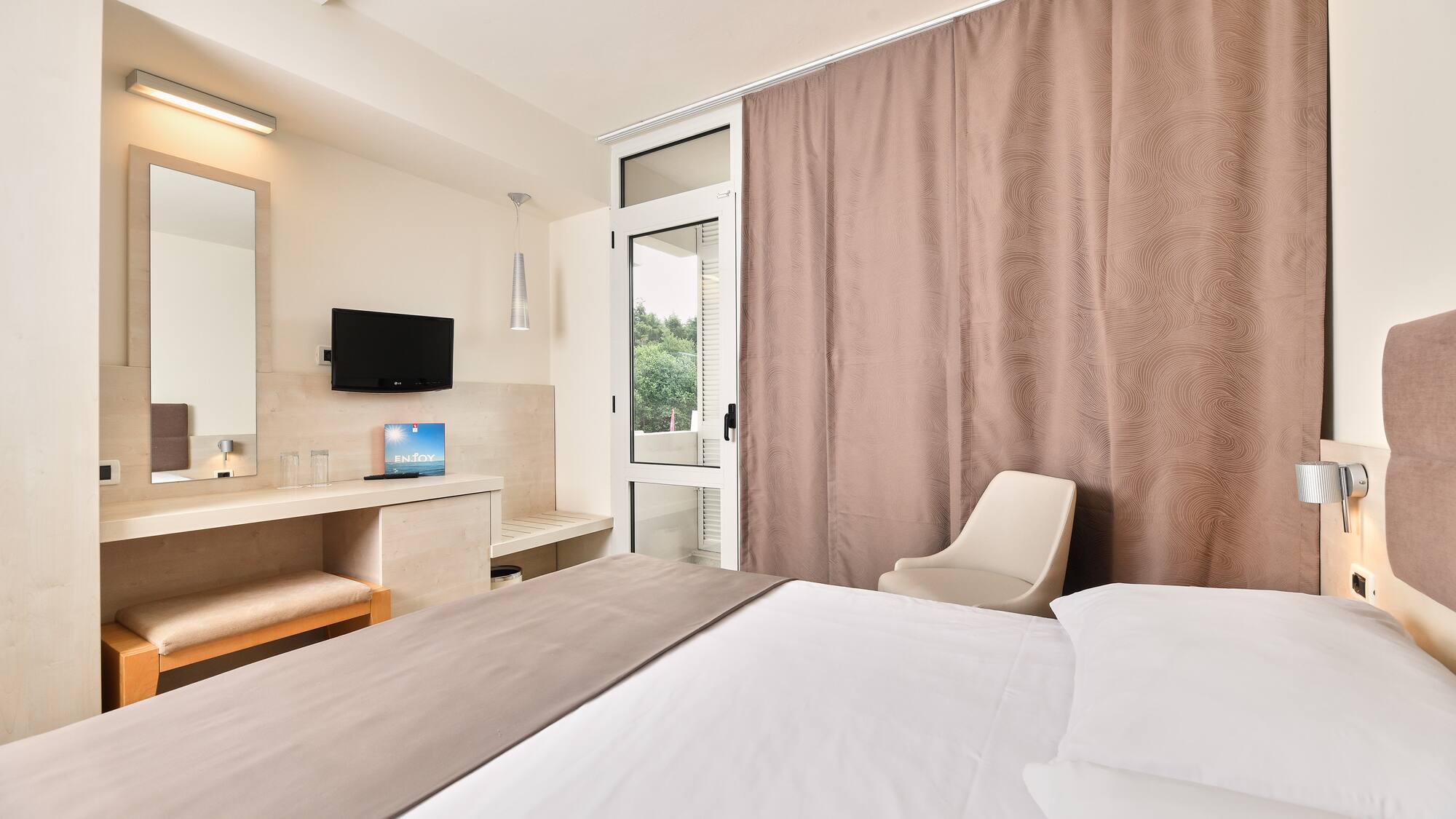 a room with a bed and a mirror