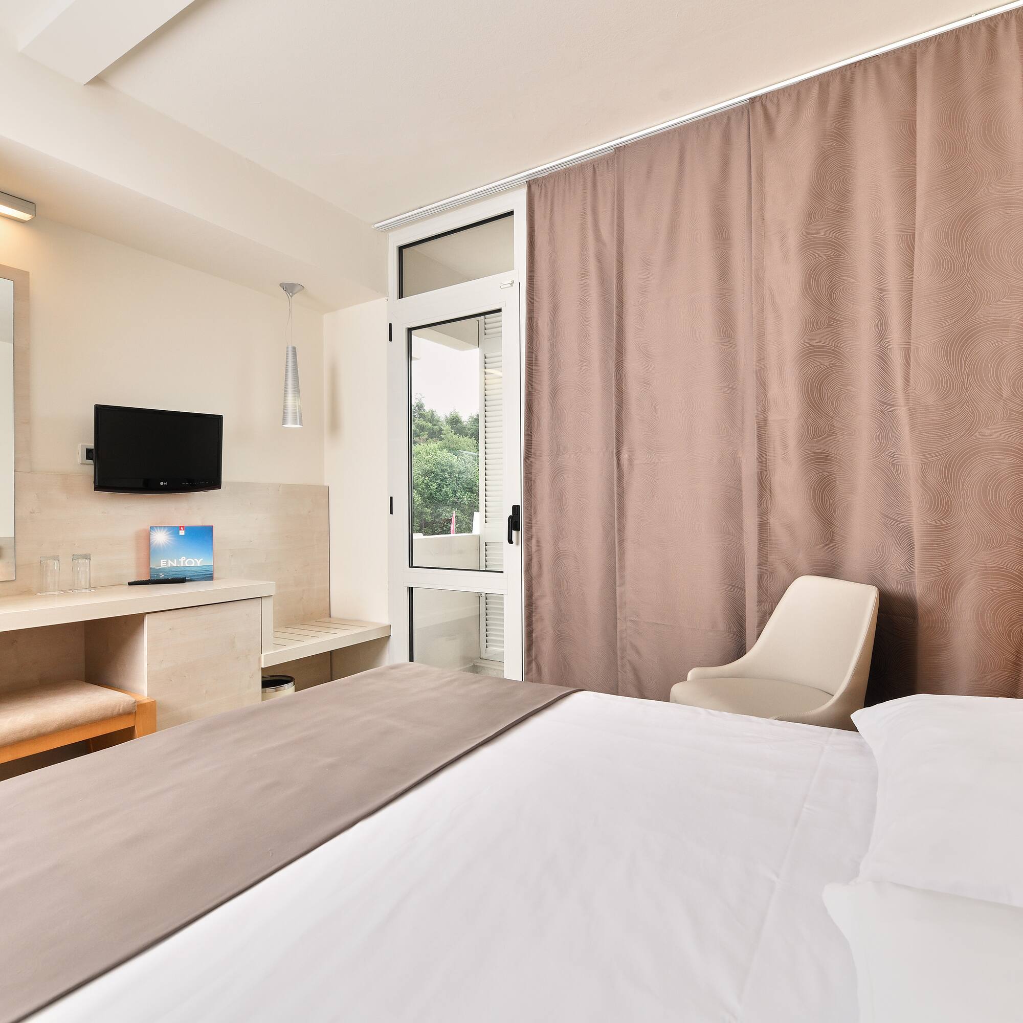 a room with a bed and a mirror