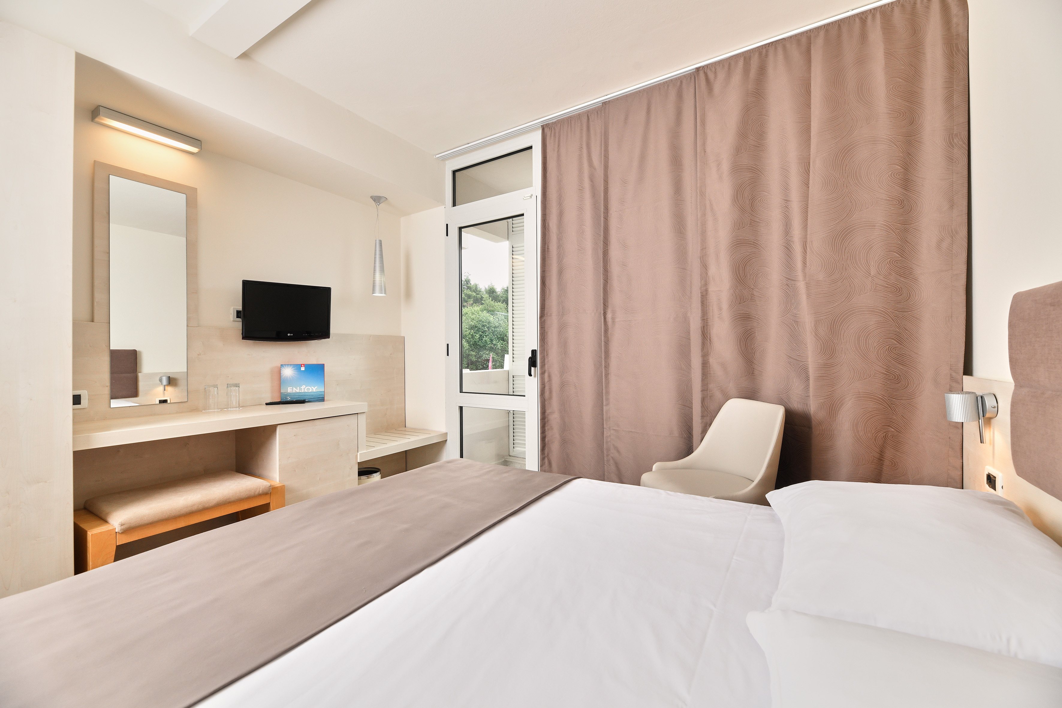 a room with a bed and a mirror