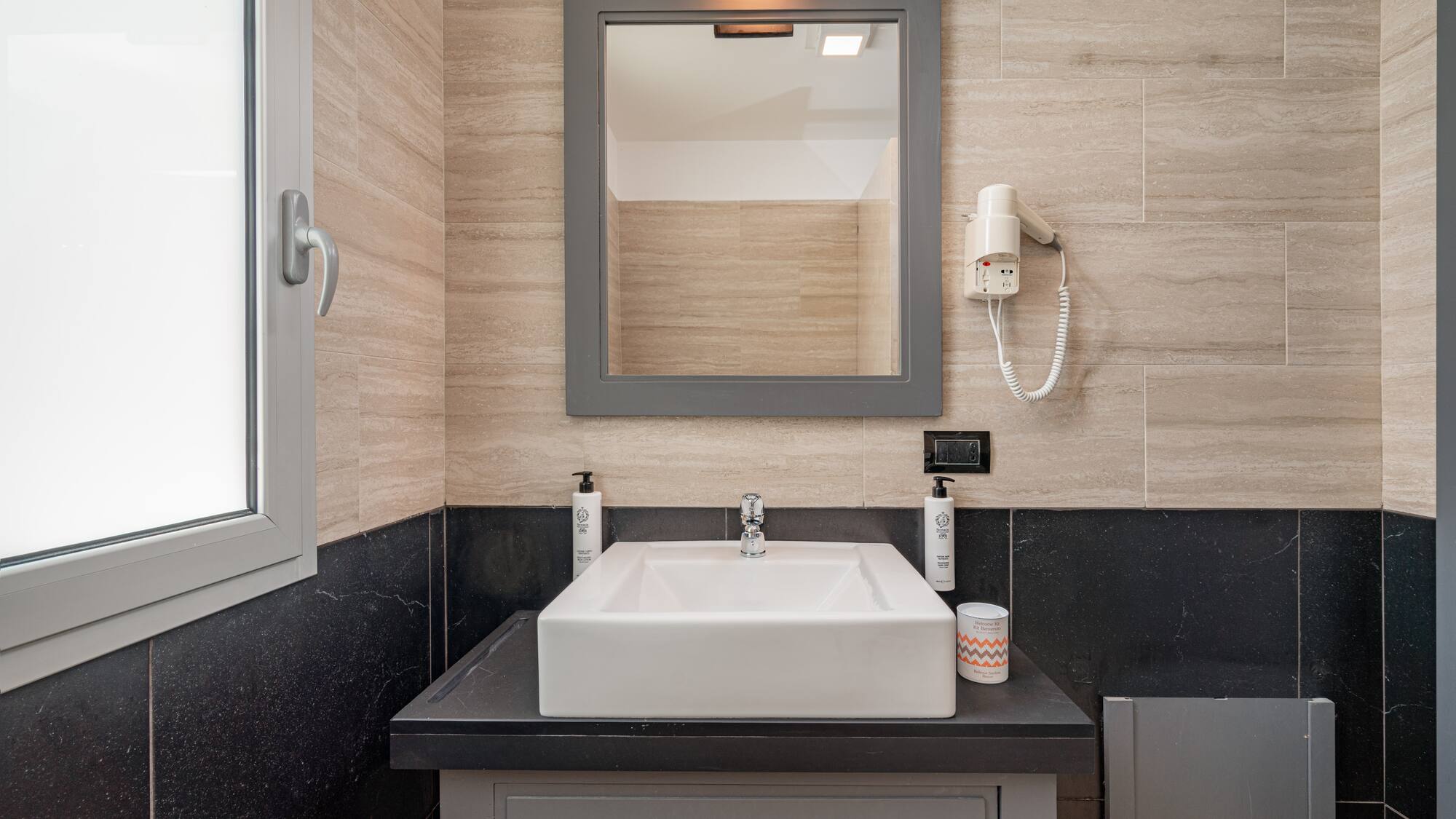 a bathroom with a mirror and sink