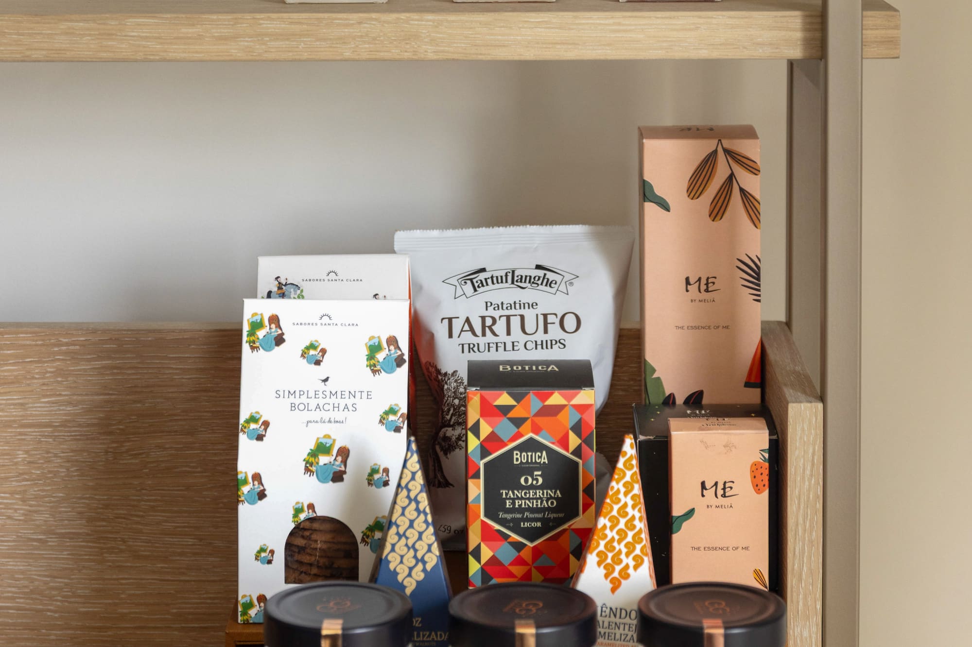 a shelf with different containers of spices
