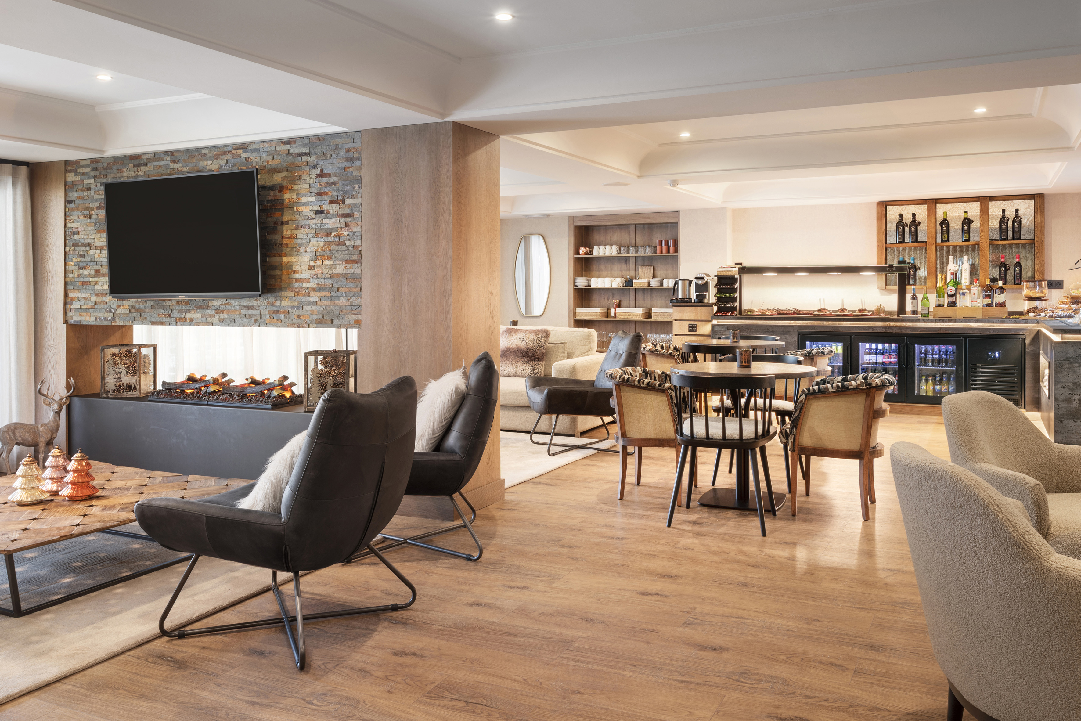 Modern hotel lounge with fireplace, comfortable seating, and buffet bar.