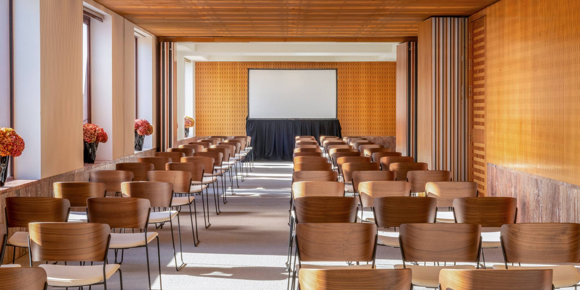 a room with chairs and a projector screen