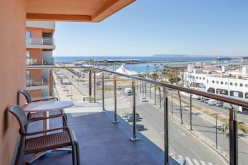a balcony with a view of the city and the ocean