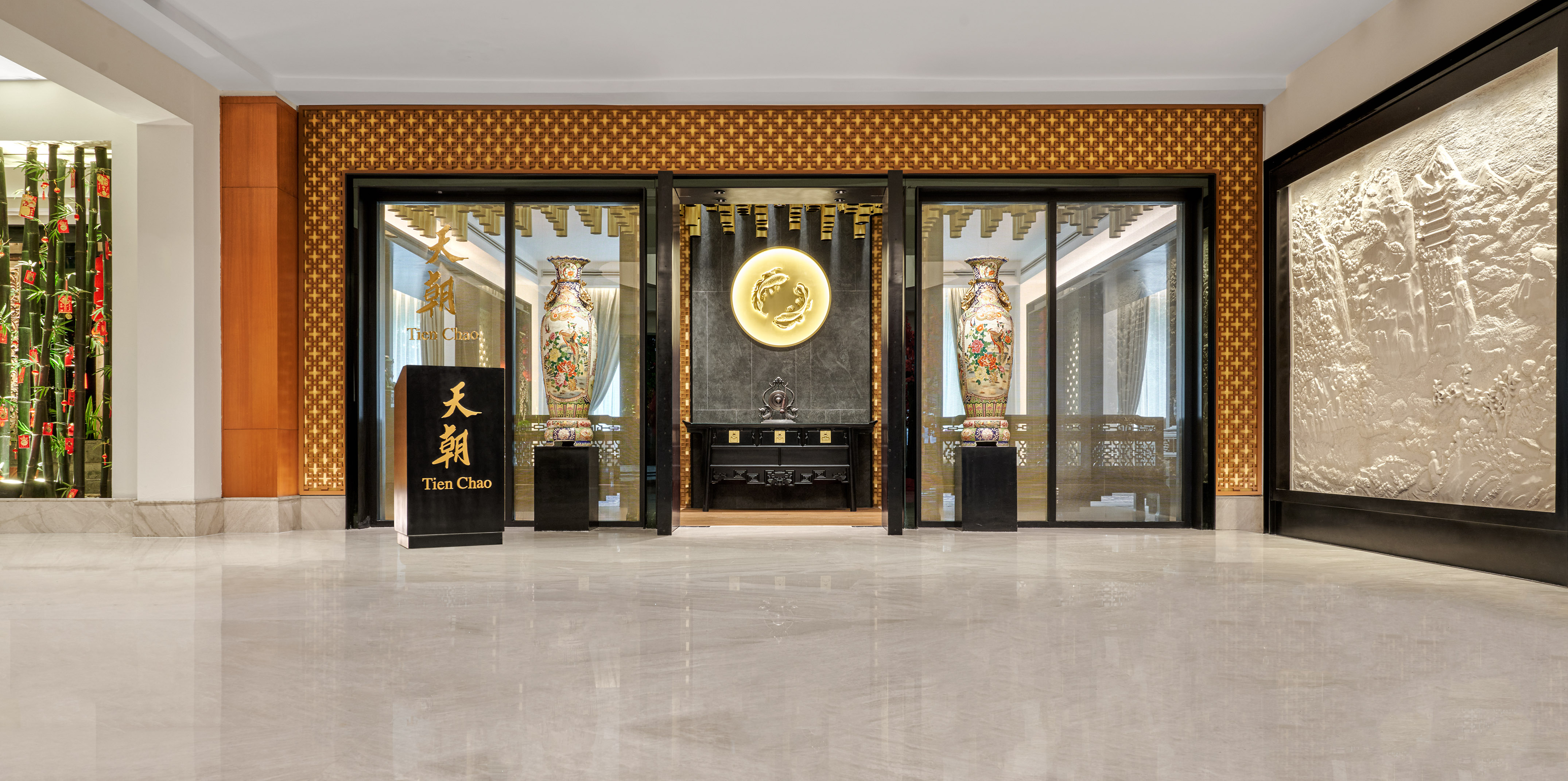 Tien Chao Chinese restaurant entrance, decorative vases, golden fish emblem, Asian decor.