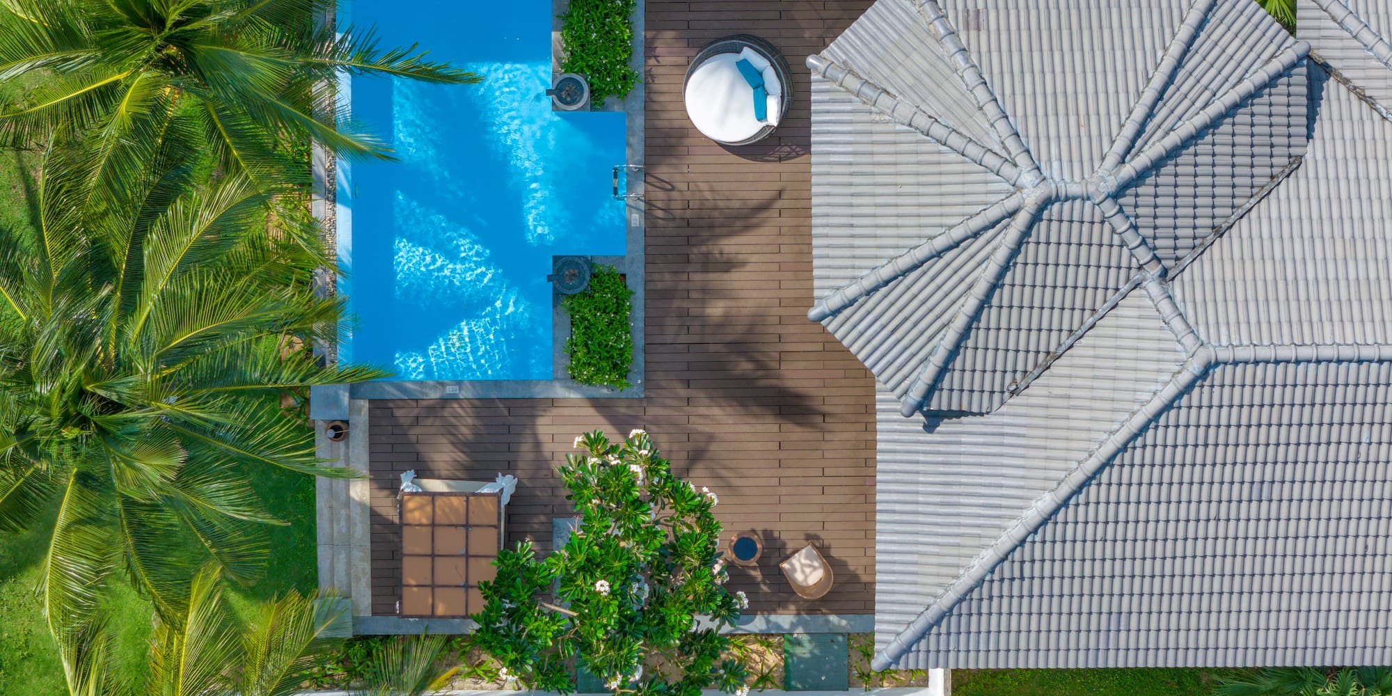 a pool and trees around a house