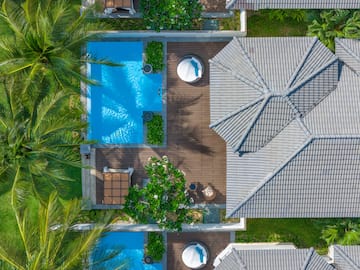 a pool and trees around a house