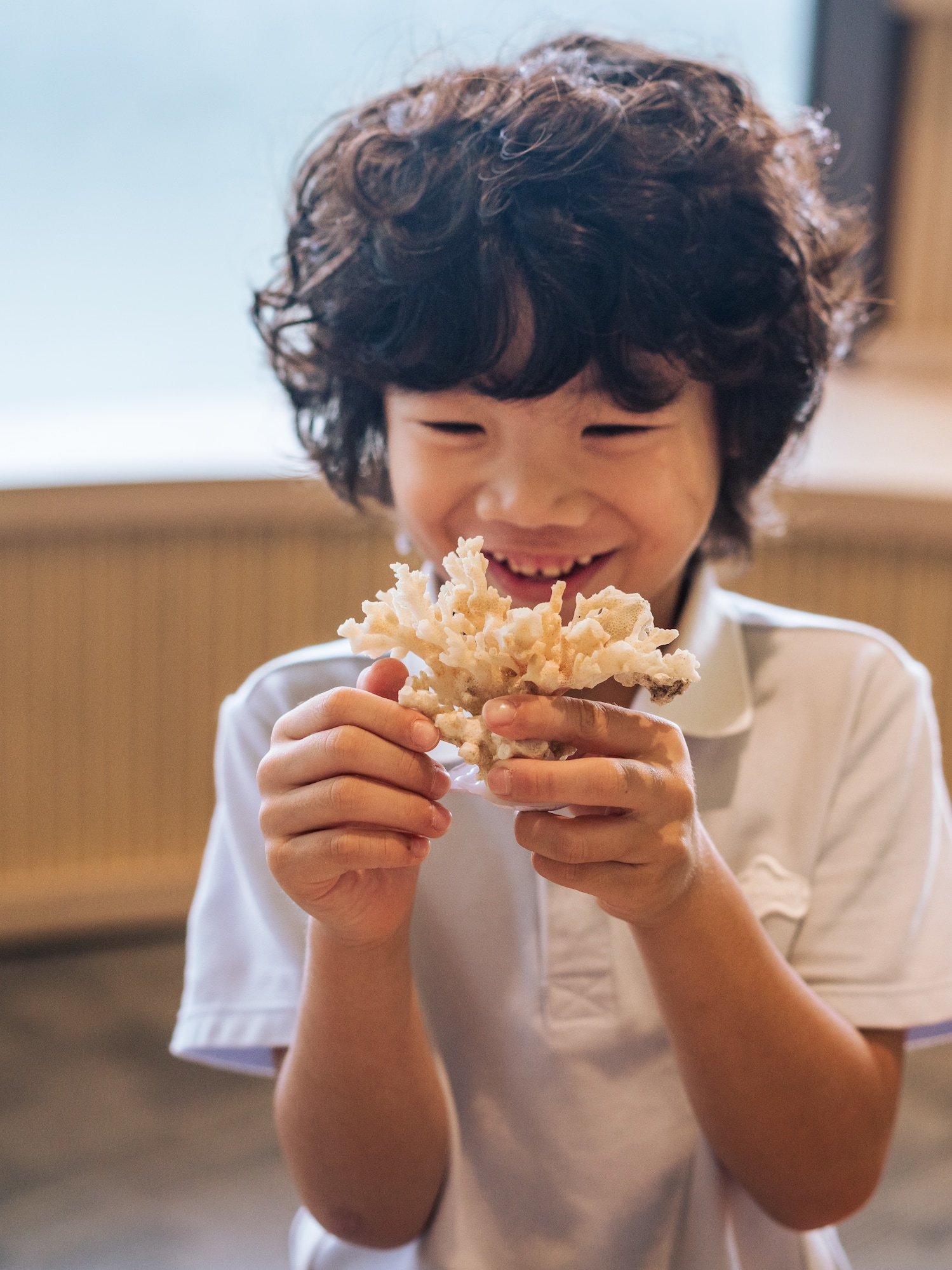 a boy holding a small container of food