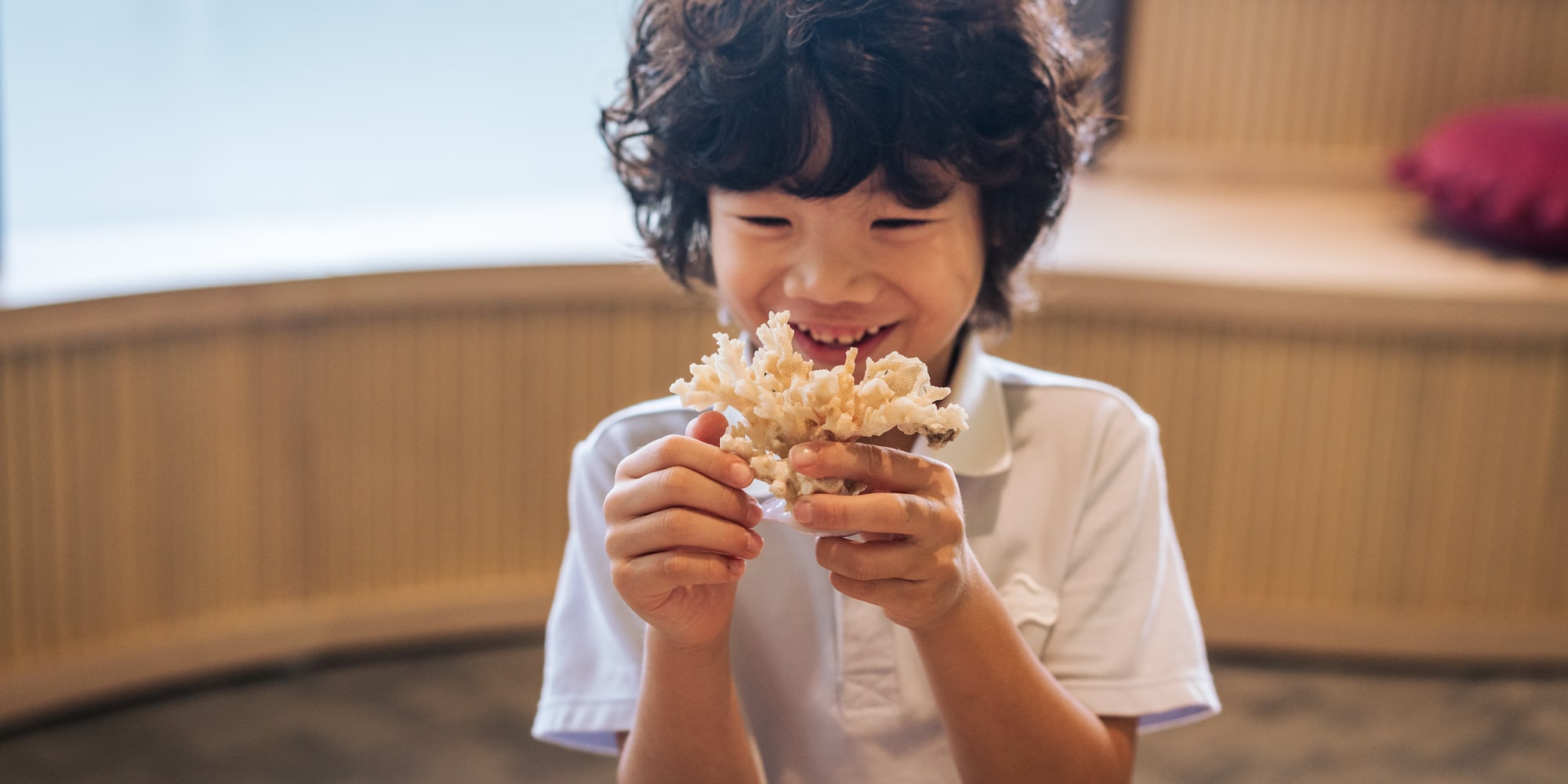 a boy holding a small container of food