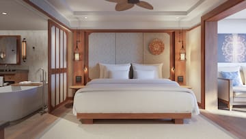 a bed with a fan and a ceiling fan